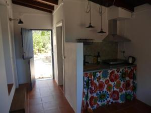 a kitchen with a counter with a counter top at Herdade Amália in Zambujeira do Mar