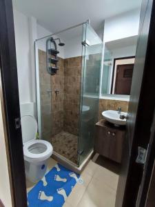 a bathroom with a shower and a toilet and a sink at Buena Vista Suites in Armenia +19 photos