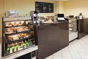a food counter in a restaurant with a refrigerator at Emporio Cancun - Buy All Inclusive Option in Cancún