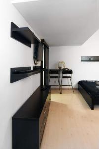 a living room with a black counter and a desk at Carol Studio in Bucharest