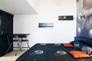 a bedroom with a bed and a desk and a chair at Carol Studio in Bucharest
