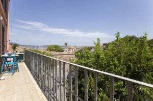 a balcony with a table and a view of the city at Dery Alghero Holiday Rooms in Alghero