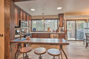 a kitchen with a table and some chairs in it at Woodsy Twin Peaks Getaway with Hot Tub and Views! in Twin Peaks