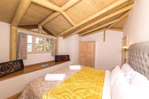 a bedroom with a bed and a wooden ceiling at Petunya Konak Boutique Hotel in Marmaris