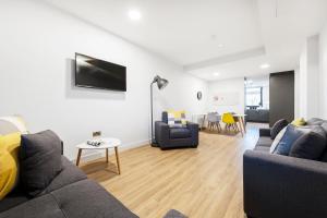 a living room with two couches and a table at Yugo Explore - Ardcairn House in Dublin