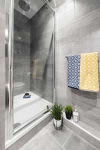 a bathroom with a shower and a bath tub at Yugo Explore - Ardcairn House in Dublin