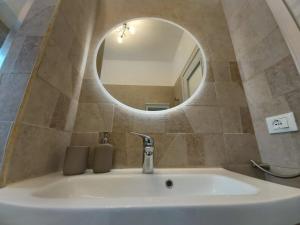 a bathroom with a sink and a mirror at Bergamo Allegra in Bergamo