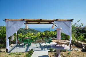 a pergola with a table and chairs on a patio at ORFEAS HOYSE 1 in Patitiri