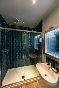 a bathroom with a shower and a sink at Escape Boutique B&B in Llandudno