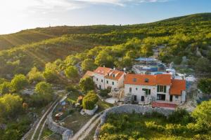 an aerial view of a large house with an orange roof at Villa Vito - with heated pool, whirlpool, gym in Šarići