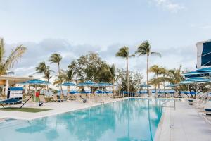 a pool at the resort with chairs and umbrellas at The Capitana Key West in Key West