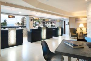 a restaurant with a bar with a table and chairs at Emporio Cancun - Buy All Inclusive Option in Cancún