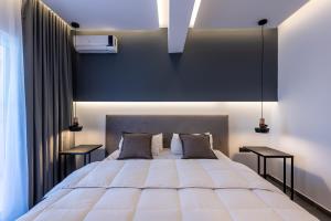 a bedroom with a large white bed with two tables at Cirillo Family Hotel-Christinas Studios in Mastihari