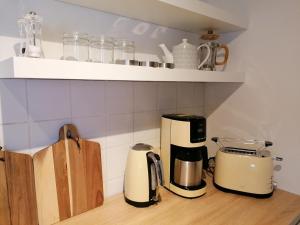 a kitchen with two toasters and a coffee maker on a counter at Loft "im Alten Pfarrhaus" in Neuruppin