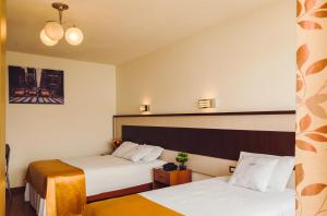 מיטה או מיטות בחדר ב-Hotel La Mansion