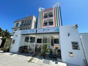 a building with a restaurant in front of it at It's Mine Hostel in Taitung City