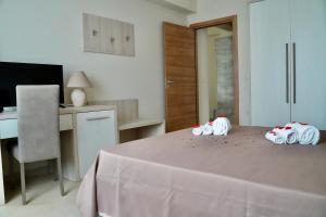 a bedroom with a bed with three toy animals on it at Hotel Roscianum Welness SPA in Rossano