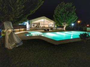 a swimming pool in a yard at night at Quinta da Amoreira in Covilhã