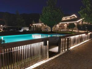 a fence around a swimming pool at night at Quinta da Amoreira in Covilhã