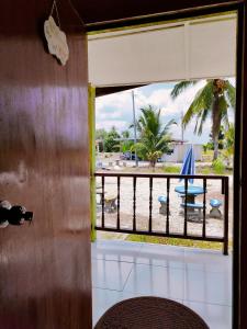 a room with a view of a beach from a window at Izz Homestay Sawah Padi Sungai Besar ! in Kampong Parit Ten