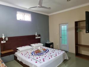 a bedroom with a large bed with a cake on it at Sunset Beach View in Dhangethi
