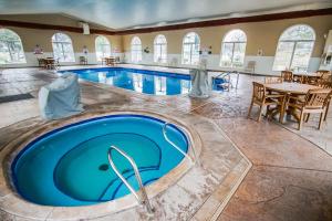 a pool in a hotel with a table and chairs at The Townhouses in Branson