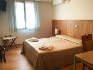 Postel nebo postele na pokoji v ubytování Hotel Al Posta
