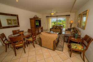 a living room with a couch and a table and chairs at Los Suenos Resort Del Mar 3I by Stay in CR in Herradura