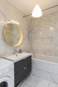 a bathroom with a sink and a washing machine at DIFY Bollier - Quartier Gerland in Lyon