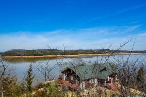 an old house in the middle of a lake at The Lookout - Lake View, Hot Tub and Grill in Dandridge