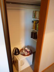 a room with a shelf with books and shoes on a table at Lesley's Bed and Breakfast in Cromwell