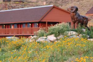 una estatua de un perro en un campo de flores en Flat Creek Inn, en Jackson