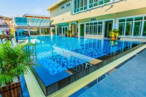 a large swimming pool in a building at Buritel Hotel in Buriram