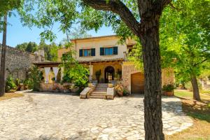 a house with a tree in front of it at Son Apiana in Mancor del Valle