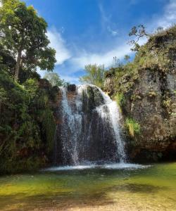 a waterfall in the middle of a body of water at Casa Localizado no Centro de Guape MG in Guapé +53 photos