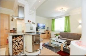 a kitchen and living room with a couch and a table at Appartement Anton in Schladming
