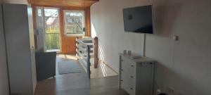 a room with a dresser and a television on the wall at Ferienwohnung in Bad Segeberg