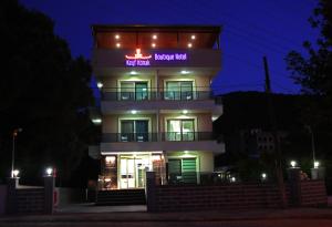 a tall building with a sign on it at night at Keyf Konak Boutique Hotel in Aydın