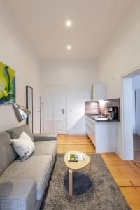 a living room with a couch and a table at Appartements an der Therme in Bad Ems