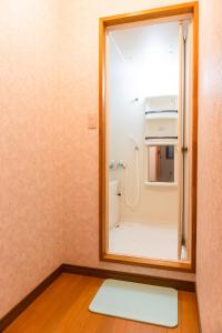 a bathroom with a mirror and a shower at La Colina Retreat - Vacation STAY 07213v in Madarao Kogen