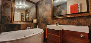 a bathroom with a white tub and a sink and a bath tub at Have it all.....City, Golf, Beaches & Countryside. in Prestonpans +30 photos