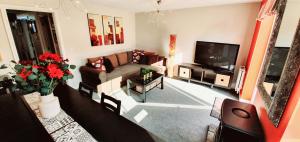 a living room with a couch and a tv at Have it all.....City, Golf, Beaches & Countryside. in Prestonpans