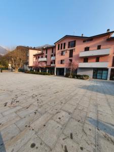 an empty parking lot in front of a building at La casa nel vento in Dervio +7 photos