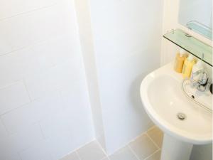 a white bathroom with a sink and a shower at Hotelette Seoul Station in Seoul