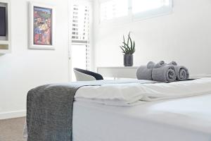 A bed or beds in a room at Bayview Boutique Guesthouse