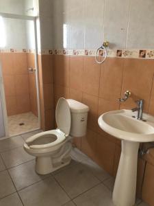 a bathroom with a toilet and a sink at 1 VENATOR House Boutique in León
