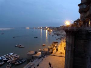 a view of a river at night with boats in it at Marigold Guest House in Varanasi