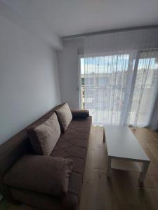 a living room with a couch and a coffee table at Ekskluziv apartmani in Paraćin