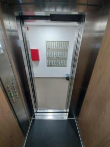 a walkway leading to a door in a elevator at Ekskluziv apartmani in Paraćin