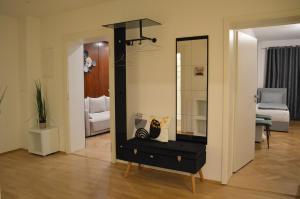 Zimmer mit einem Spiegel und einer schwarzen Kommode in der Unterkunft New City Center Stays 2 in München
